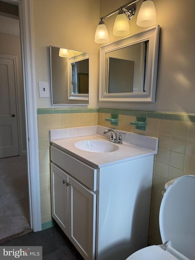 bathroom featuring vanity and tile walls