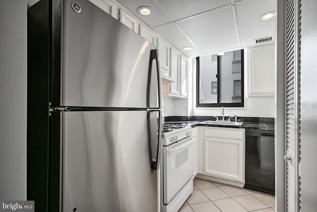 kitchen with dishwasher, stainless steel fridge, white cabinets, and white range with gas cooktop