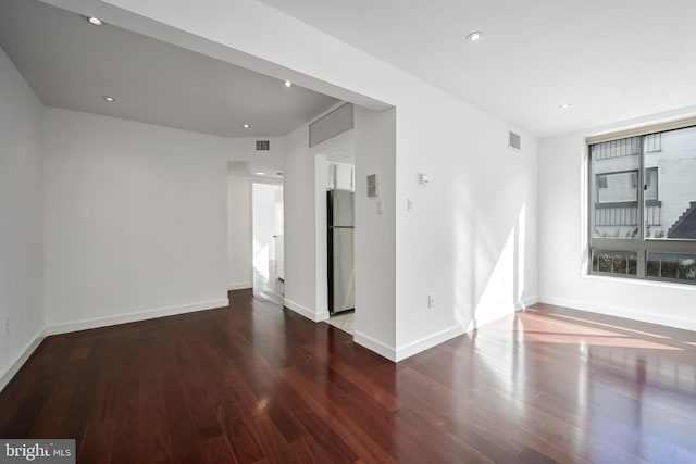 empty room with dark wood-type flooring