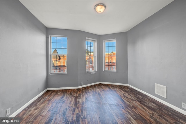 empty room featuring dark wood-type flooring