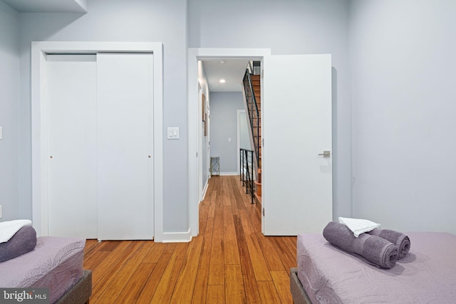 bedroom with a closet and hardwood / wood-style floors