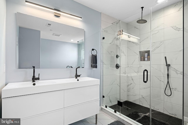 bathroom featuring vanity and a shower with shower door