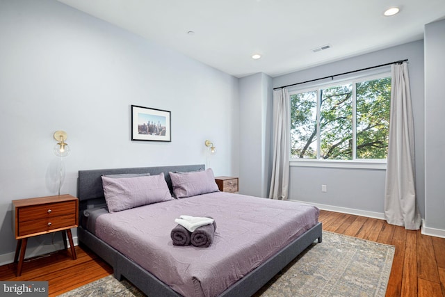 bedroom with hardwood / wood-style floors