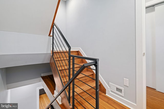 stairway featuring wood-type flooring