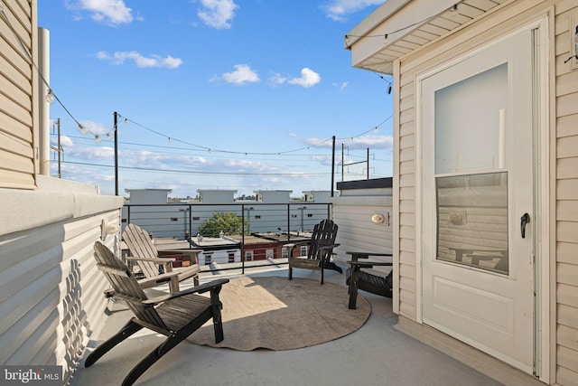 view of patio featuring a balcony