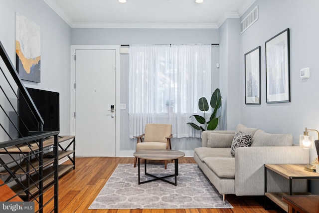 living room featuring crown molding and hardwood / wood-style flooring