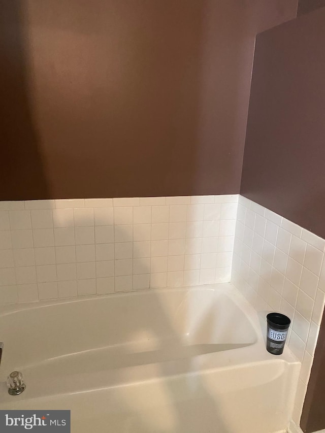 full bathroom with a bath