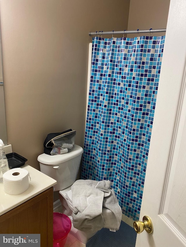 bathroom with vanity, toilet, and walk in shower