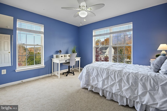 bedroom with carpet flooring, multiple windows, and ceiling fan