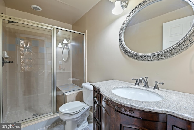 bathroom featuring vanity, toilet, and a shower with shower door