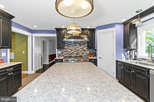 kitchen with sink, dishwasher, backsplash, decorative light fixtures, and dark hardwood / wood-style floors