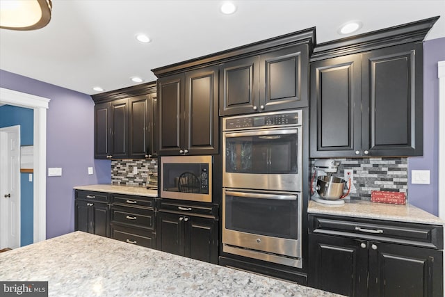 kitchen featuring stainless steel appliances and backsplash