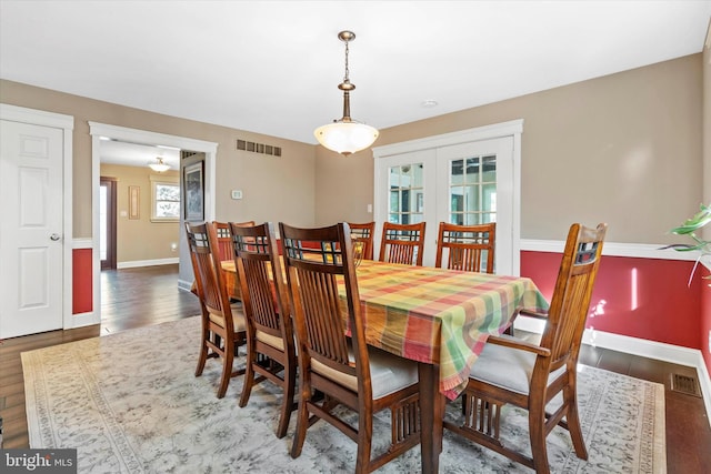 dining room with french doors and dark hardwood / wood-style flooring