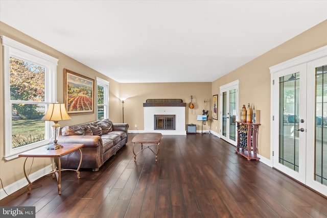 living room featuring french doors, dark hardwood / wood-style floors, and a fireplace