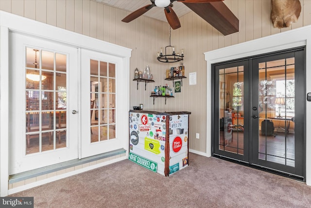 playroom with french doors, wood walls, and carpet