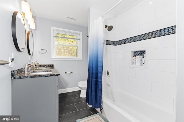 full bathroom featuring vanity, toilet, shower / bath combo with shower curtain, and tile patterned flooring