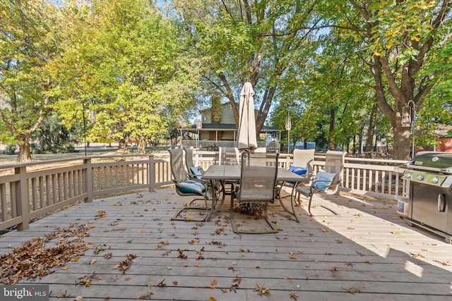 wooden terrace featuring area for grilling