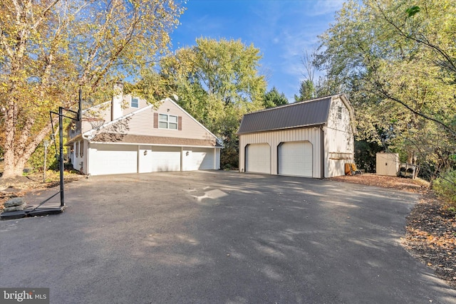 view of side of home featuring an outbuilding and a garage