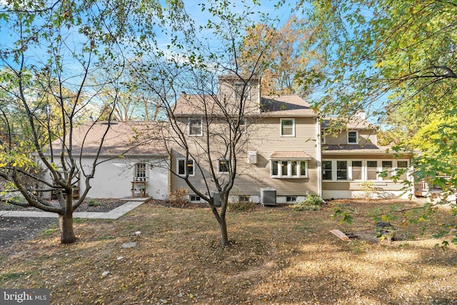 rear view of property featuring central AC unit