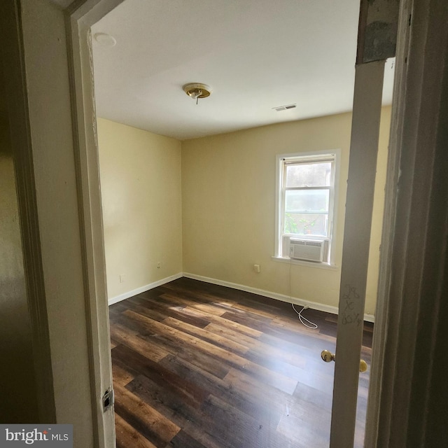 empty room featuring dark wood-type flooring and cooling unit