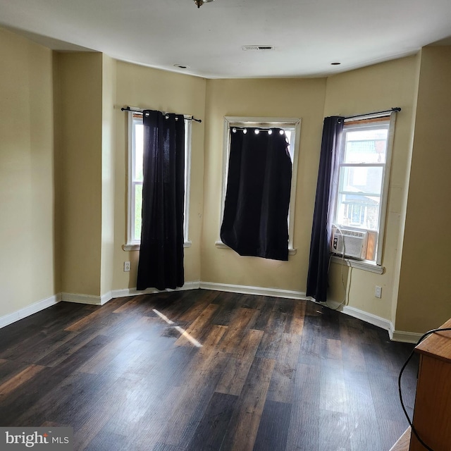 empty room featuring dark hardwood / wood-style flooring