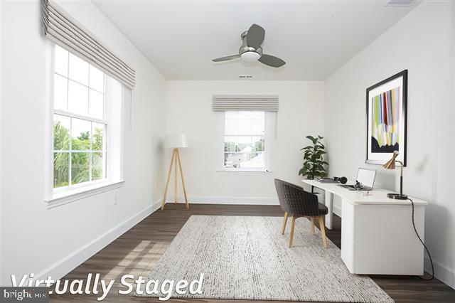 office with dark hardwood / wood-style floors and ceiling fan