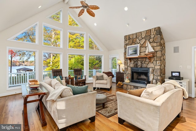 living room featuring light hardwood / wood-style floors, high vaulted ceiling, and a wealth of natural light