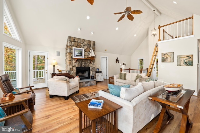 living room featuring light hardwood / wood-style floors, beam ceiling, high vaulted ceiling, and ceiling fan