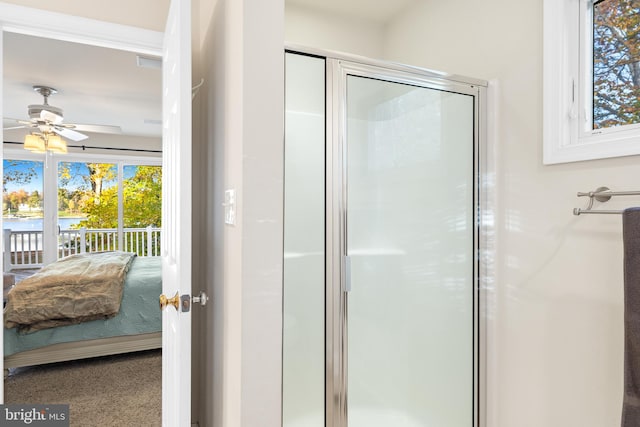 bathroom featuring walk in shower and ceiling fan