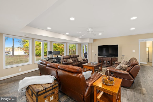 living room featuring ceiling fan and dark hardwood / wood-style flooring