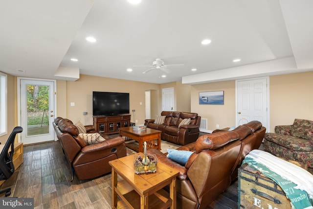 living room featuring dark hardwood / wood-style floors and ceiling fan