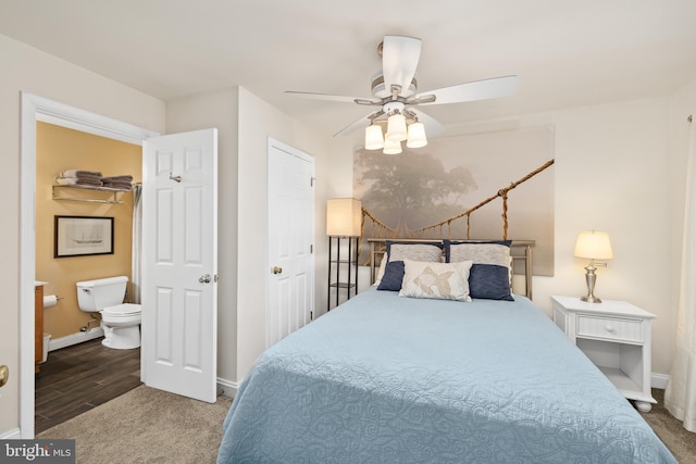 bedroom featuring ensuite bathroom, hardwood / wood-style flooring, a closet, and ceiling fan