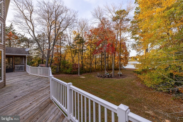 wooden deck with a yard and a sunroom