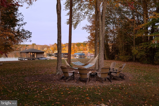 yard at dusk with a gazebo and a water view