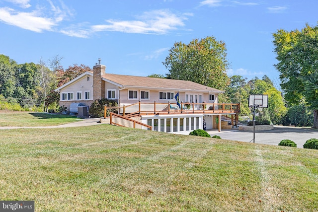 back of house with a yard and a deck