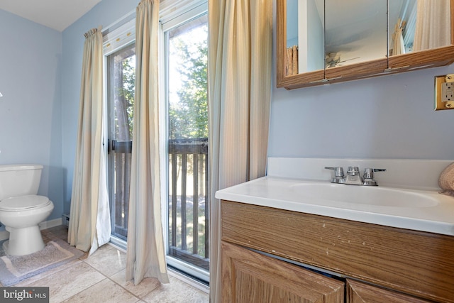 bathroom with vanity, toilet, and tile patterned floors