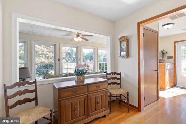 sitting room with light hardwood / wood-style floors, plenty of natural light, and ceiling fan