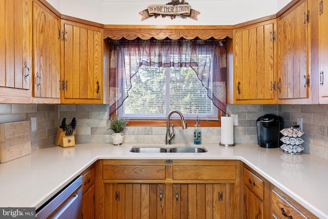 kitchen with sink, decorative backsplash, and dishwasher