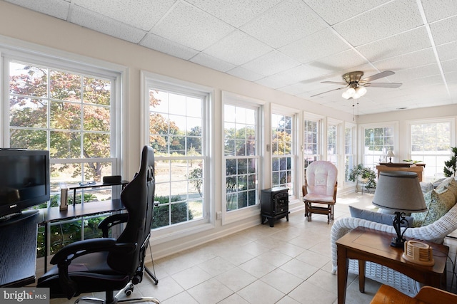 sunroom with a wealth of natural light, a drop ceiling, and ceiling fan