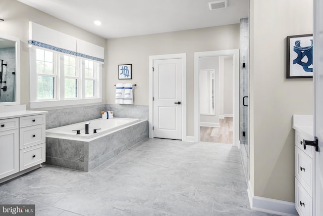 bathroom with vanity and independent shower and bath