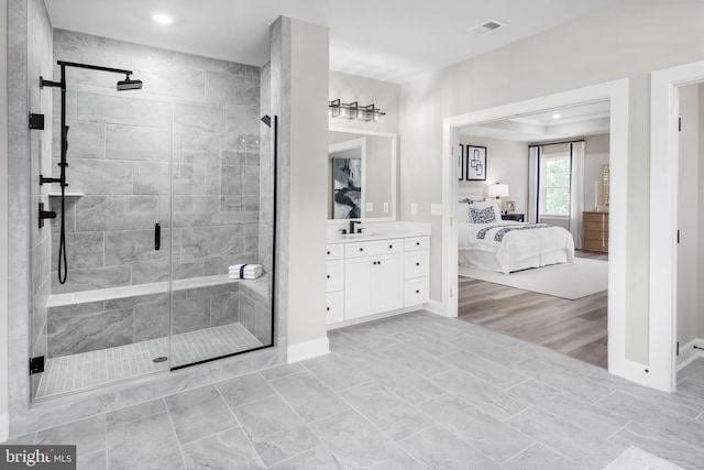 bathroom with vanity, walk in shower, and wood-type flooring