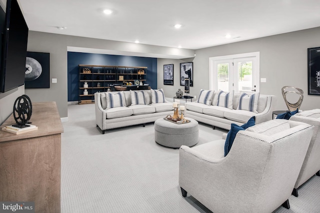 living room featuring french doors and light carpet