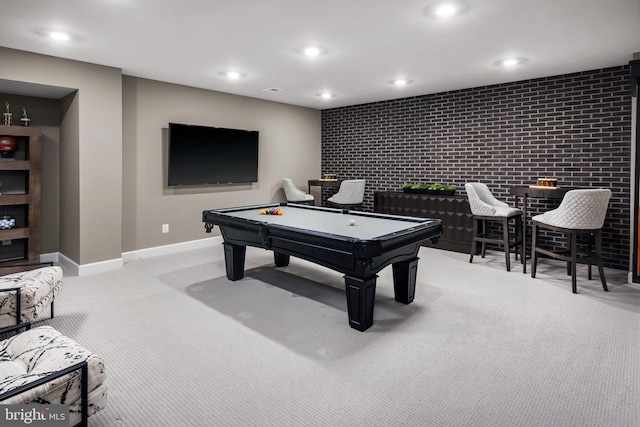 playroom with brick wall, light colored carpet, and billiards