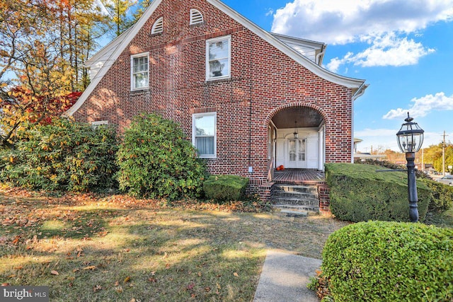 tudor home featuring a front lawn