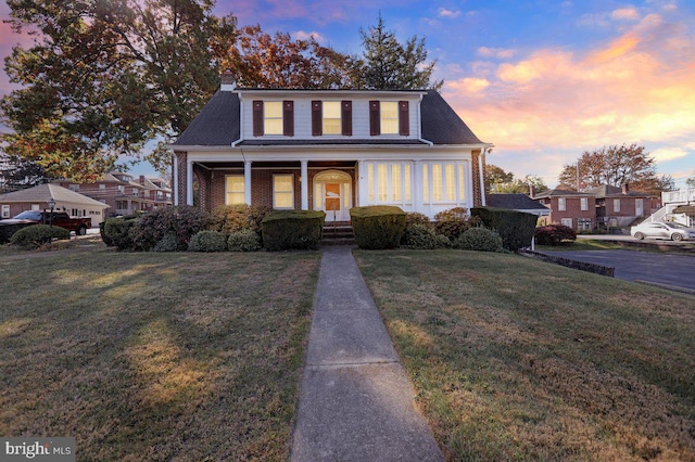 view of front of property with a yard and a porch