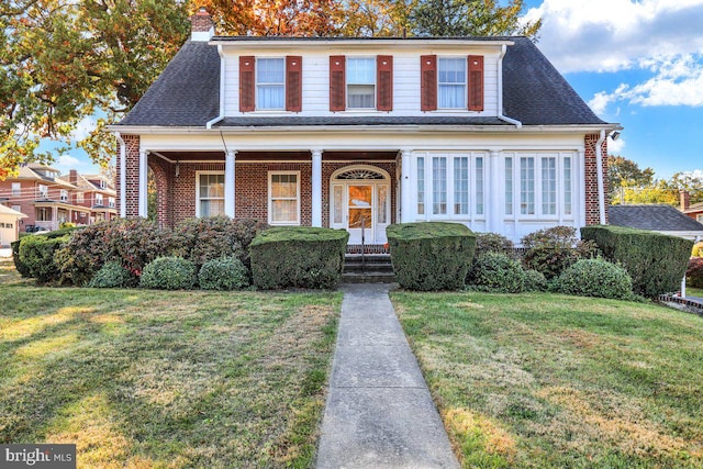 view of front of property with a porch and a front yard