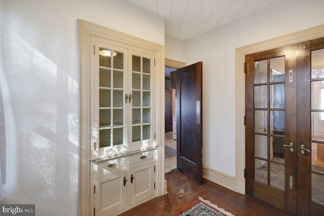 hall with french doors and dark hardwood / wood-style floors