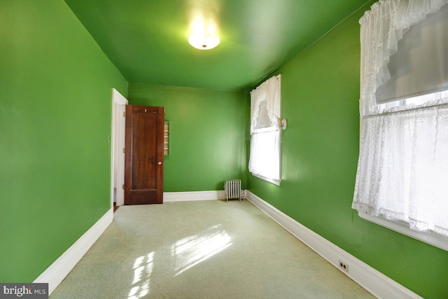 interior space featuring radiator heating unit and carpet