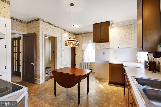 kitchen with decorative light fixtures and sink