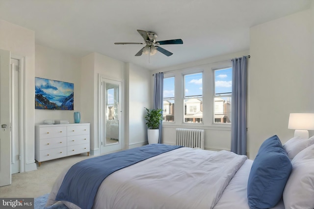 bedroom featuring radiator, ceiling fan, and light colored carpet